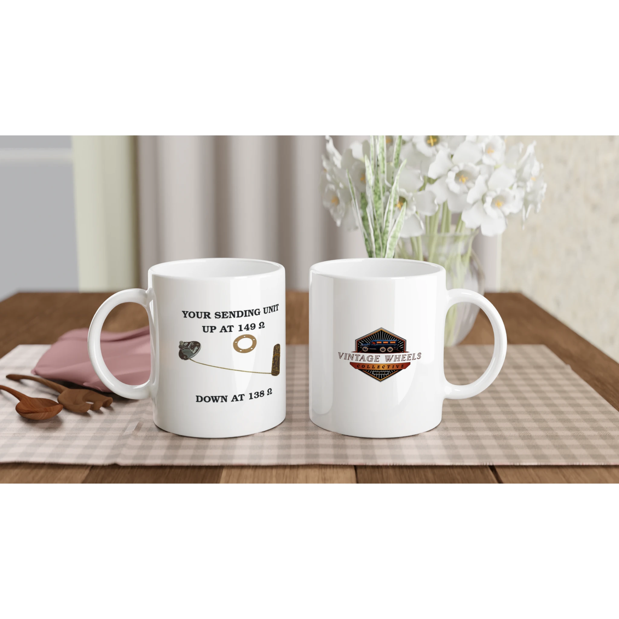 Set of Undeniable Fuel Sending Unit 325ml white ceramic mugs on a dining table, featuring fuel sender design and vintage logo, perfect for garage or kitchen.