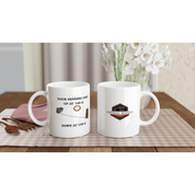 Set of Undeniable Fuel Sending Unit 325ml white ceramic mugs on a dining table, featuring fuel sender design and vintage logo, perfect for garage or kitchen.