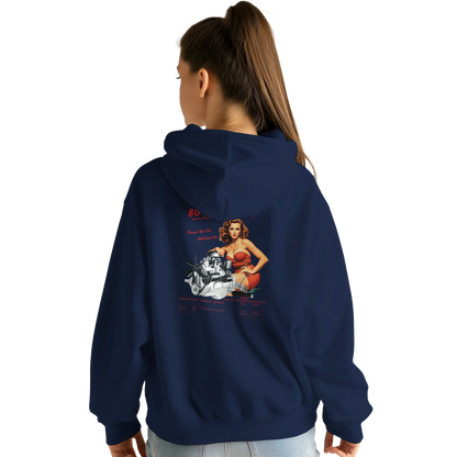 Female model in STRAIGHT SERIES T223 COMFY HOODIE with bold back print of T223 Straight-6 engine and retro pin-up, perfect for gearheads.