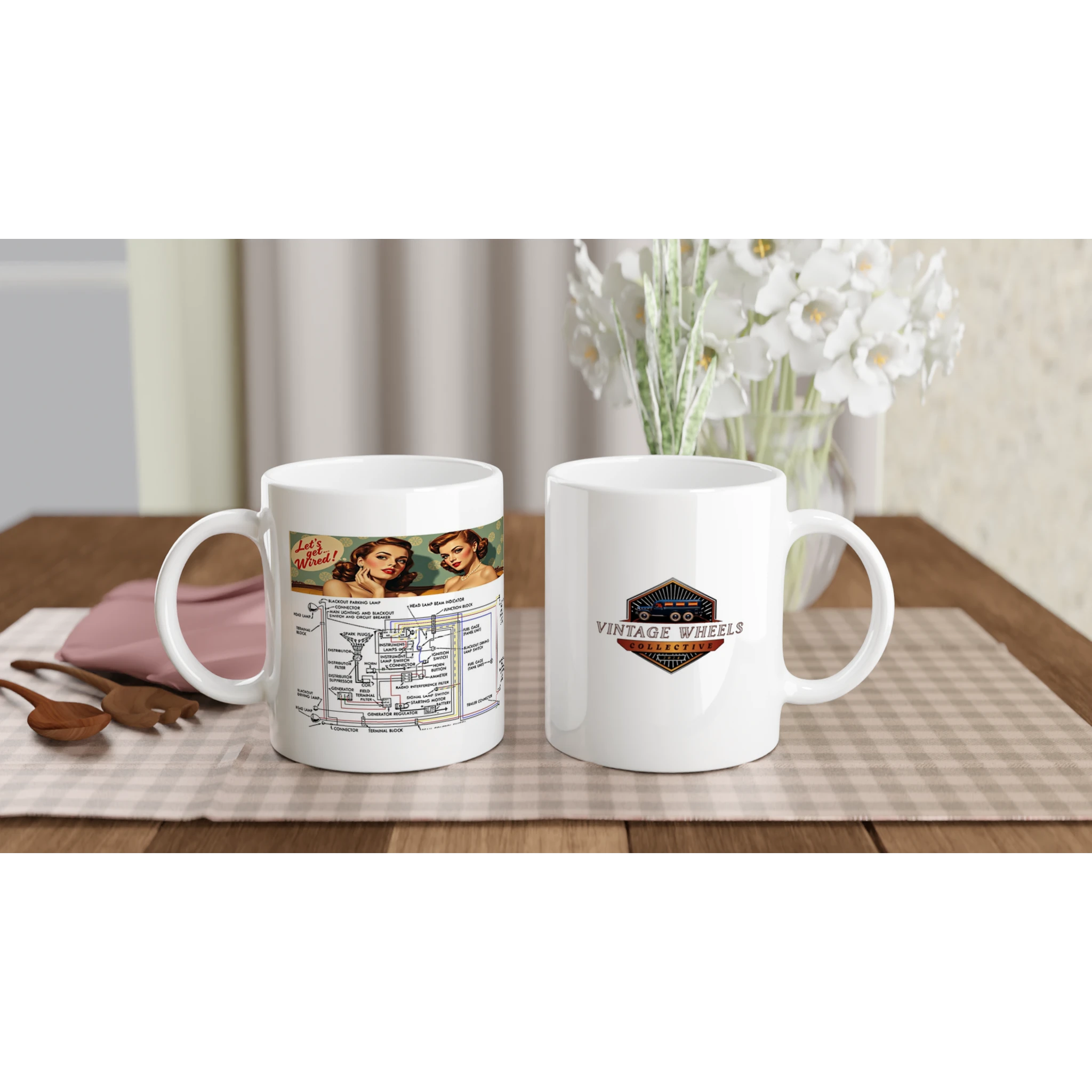 Set of two UNDENIABLE LETS GET WIRED 325ml white ceramic mugs on a dining table, featuring vintage wiring design and Vintage Wheels logo.